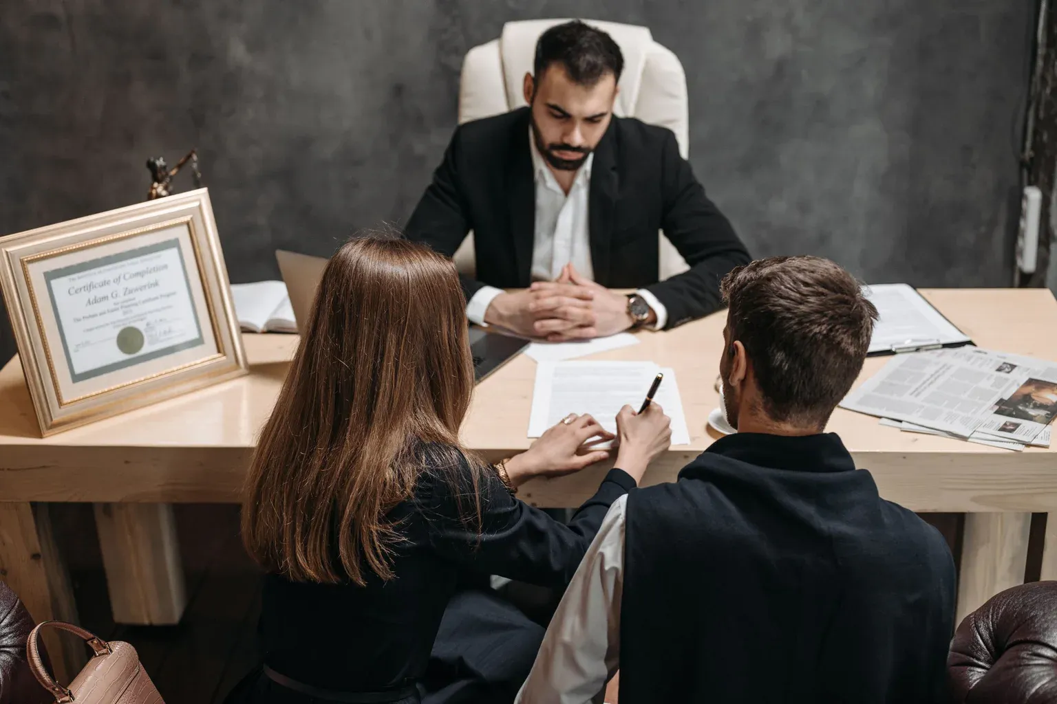 A lawyer reviewing documents with clients during a consultation