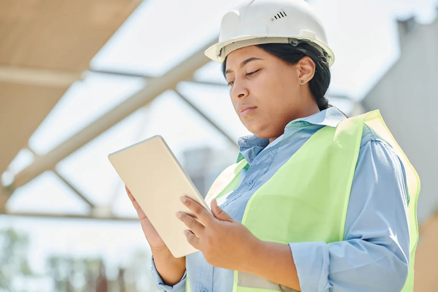 A civil engineer using a tablet while working on site
